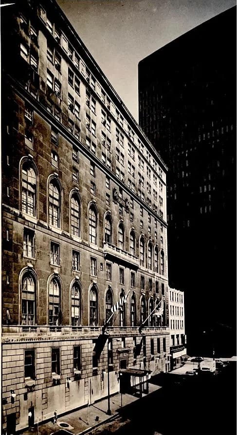 The Standard Club’s last clubhouse at 320 South Plymouth Court in black and white, rows of arched windows along its stone facade and a dark office tower beside it.